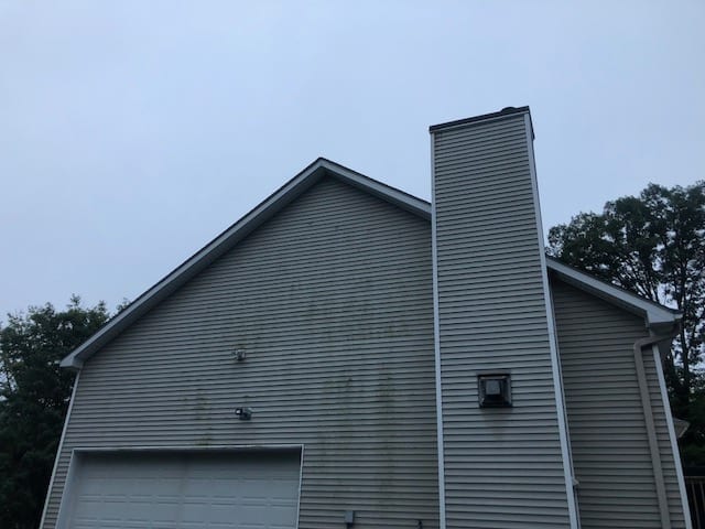 house with dirty siding before cleaning- westchester power washing, ARE YOU LOOKING FOR A FREE RYE BROOK ROOF WASHING OR HOUSE PRESSURE CLEANING ESTIMATES? DO YOU WANT YOUR RYE BROOK SLATE OR SHINGLE ROOF SHAMPOOED OR SOFT WASHED? IS THERE DIRT, BLACK STREAKS, MOLD, MILDEW, LICHENS, MOSS OR FUNGUS ON YOUR SLATE OR SHINGLE ROOF? SEARCHING FOR PRESSURE WASHING FOR YOUR HOUSE, SIDING, PATIO, DECK, FENCE, BRICKS, PAVERS, SLATE OR STONE WALKWAY IN RYE BROOK? If the answer is yes to any of these Rye Brook house or roof cleaning questions, call 914-490-8138. Westchester Power Washing will give you a free roof cleaning and house pressure cleaning estimate. We shampoo roofs and pressure wash houses in Westchester, Putnam and Dutchess County, NY. Call or text Peter Salotto, owner of Westchester Power Washing at (914) 490-8138. In addition to cleaning slate, asphalt and shingle roofs, Westchester Power Washing offers our Always Clean Roof Guarantee. Furthermore, we offer the best customer service in Rye Brook and we are properly insured. Since 1990, we have pressure washed more than 18,000 homes, siding, walkways, patios, fences, decks and roof soft washing services. Some of the towns we provide roof washing and pressure cleaning include: RYE ARMONK SCARSDALE KATONAH CHAPPAQUA WESTCHESTER POWER WASHING IS THE MOST RECOMMENDED PRESSURE AND ROOF CLEANING BUSINESSES IN RYE BROOK. Peter Salotto is and expert at removing grease, oil, stains, dirt, moss,lichens, mildew, grass, weeds and fungus from your house, siding, roof and walkways. He deep pressure cleans your house, siding, decks, patios, walkways and pavers. This includes pressure cleaning brick, stone, composite decks, wood and cement surfaces. As well as cobblestones, pressure treated wood, trex deck, composite and vinyl surfaces. SHOULD YOU CALL A ROOF CONTRACTOR OR A ROOF CLEANING COMPANY TO CLEAN YOUR RYE BROOK ROOF? Wonder if you call a roof contractor or roof washing company when your roof is dirty? If your roof has black streaks, mold, mildew, lichens or moss, your roof needs to be cleaned. Many people call the local roofing company or roof contractor when their roof needs cleaning. But, roofing contractors are not your best choice. Roof contractors and roofing companies make money installing roofs and replacing roofs. Furthermore, slate, shingle and asphalt roof replacement is expensive and profitable for roofers. As a result, some advise you to replace your roof or sections of your slate, asphalt or shingle roof instead of having your roof soft washed. A dirty roof does not need to be replaced. Professionally clean a dirty roof, do not replace it. Replacing your slate, shingle or asphalt roof can cost thousands of dollars more than a roof shampoo or soft roof wash by Westchester Power Washing. If you notice your roof is dirty, the best person to call is Peter Salotto with Westchester Power Washing 914-490-8138. The call is free and Peter will give you free roof cleaning quote. WHAT IS RYE BROOK ROOF SOFT WASHING? Soft roof washing is the safest and best low pressure cleaning method. Soft washing professionally cleans and sanitizes your homes roof using low pressure equipment with our eco-friendly soft washing cleaning product. Our soft roof cleaning method kills, removes and prevents black stains associated with mold, mildew, lichen, pollen, algae, moss and fungi growth. Soft roof washing treats the root cause of the mold and mildew growths by killing the bacteria and fungus spores without harming your home, people, pets or environment. In addition, soft washing keeps your roof clean longer. In addition, we guarantee our soft roof washing technique will keep your roof black streak free for up to 5 years. IS SOFT ROOF WASHING BETTER THAN PRESSURE CLEANING MY ROOF? To begin with, we use a power washer to soft wash your home and roof. This is the same power washer that is used to high pressure wash driveways, decks, patios and walkways. So, the difference is not the equipment, it is the nozzle. We soft wash your roof. We never pressure clean your roof. The pressure cleaner nozzle we use regulates the amount of water pressure. To soft wash, we use very low water pressure. This eliminates the potential for your home or roof to be damaged. With high pressure washing, massive amounts of water pressure is used. High pressure roof washing can give you fast results that look good but this may last for a short period of time. High pressure washing blasts dirt and grime. Unfortunately, this also mean your shingles or slate roof is also being blasted and damaged at the same time. Furthermore, Westchester Power Washing is a dedicated, experienced and professional roof and pressure washing company. We work carry liability and workers compensation insurance specifically for roof cleaning and pressure washing. Most companies are not insured to protect your, your home or their employees by carrying the proper insurance. We’ve been in the roof cleaning and pressure washing business for almost 30 years. Many handyman and other companies that do roof cleaning and pressure washing services have bad reputations. Our service are rated 5 stars and as the Best on Google Business Review, many facebook groups in Westchester County and on many other websites. We are residential home exterior cleaning experts, it is what we do all year long. In addition, our residential cleaning expertise our power washing won’t disturb your trees, shrubs, and flower beds. In addition, we take every precaution to protect your furniture, home, landscape and lawn. We use a professional grade power washer with eco-safe, environmentally-friendly cleaners. We know how to remove algae, oil, dirt and grime off of your concrete, brick, pavers, and stonework. RYE BROOK POWER WASHING + RYE BROOK PRESSURE WASHING + RYE BROOK ROOF WASHING BENEFITS OF PROFESSIONAL PRESSURE WASHING (POWER-WASHING) WITH WESTCHESTER POWER WASHING INCLUDES: remove dirt, oil stains from home, drive, roof and walkways Remove black streaks, mold, mildew, lichens and moss from your roof clean and brighten fences, play equipment and yard furniture make your home’s exterior cleaner and more sanitary for children remove plants and weeds growing where they shouldn’t. prepare an area for a painting or staining project. Get a home ready to be sold or for remodeling Increase your home’s value and curb appeal Westchester Power Washing provides RYE BROOK residential homeowners FREE House, Roof, Siding, Deck, Sidewalk and Patio cleaning estimates and quotes- call 914-490-8138. IF YOU WANT TO CONTACT DIRECTLY ON OUR WEBSITE CLICK HERE. TOWNS WE PROVIDE PRESSURE WASHING AND POWER WASHING, HOME EXTERIOR & SIDING WASHING, ROOF SOFT WASHING, PRESSURE WASH PATIOS, DECKS, FENCES, OUTDOOR FURNITURE, STONE AND BRICK PAVERS: Ardsley NY 10502, Armonk NY 10504, Bedford NY 10506, Bedford Hills NY 10507. Briarcliff Manor 10510, Chappaqua NY 10514, Brewster NY 10509, Carmel (Kent) NY 10512, Cortlandt Manor NY 10567, Croton on Hudson NY 10520. Dobbs Ferry NY 10522, Eastchester NY 10709, Goldens Bridge NY 10526. Harrison NY 10528,Hartsdale NY 10530, Hawthorne NY 10532, Hopewell Junction NY 12533,Irvington NY 10533, Katonah NY 10536, Larchmont NY 10538. Mahopac NY 10541,Mamaroneck NY 10543, Millwood NY 10546, Mohegan Lake NY 10547, Montrose NY 10548, Mt. Kisco NY 10549, New Rochelle NY 10804, 10801, 10802, 10803, 10805,North Salem NY 10560, Ossining NY 10562, Pleasantville NY 10570. Pound Ridge NY 10576, Purchase NY 10577, Putnam Valley NY 10579, Rye NY 10580, Rye Brook NY 10573. Scarsdale NY 10583, Sleepy Hollow NY 10591, Somers NY 10589, South Salem NY 10590, Tarrytown NY 10591, Thornwood NY 10594. Valhalla NY 10595,Waccabuc NY 10597, West Harrison 10604, Westchester. White Plains NY 10601,10602,10603,10604,10605,10606,10607, Yorktown Heights NY 10598 Furthermore, our other Pressure washing site for your convenience is Power Washing Westchester.com